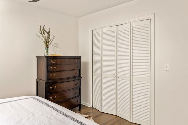 bedroom featuring visible vents, wood finished floors, and a closet