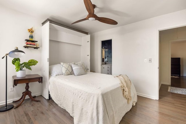 bedroom featuring baseboards, wood finished floors, and a ceiling fan