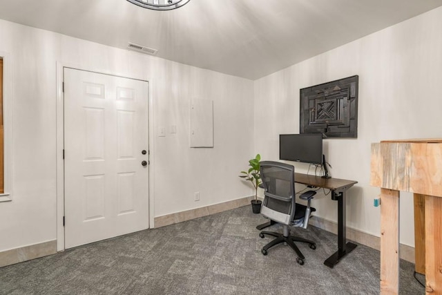 carpeted office featuring visible vents and baseboards