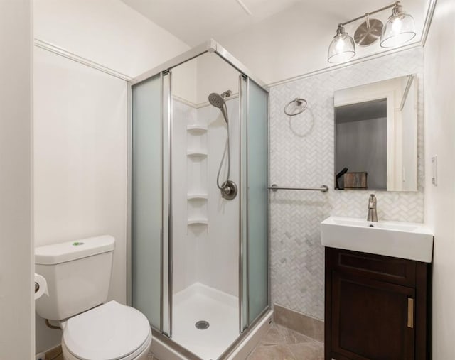 bathroom with vanity, toilet, and a stall shower