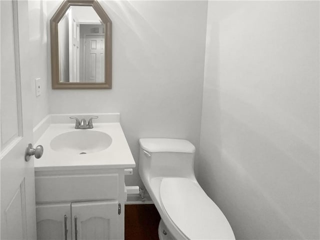 bathroom featuring vanity and toilet