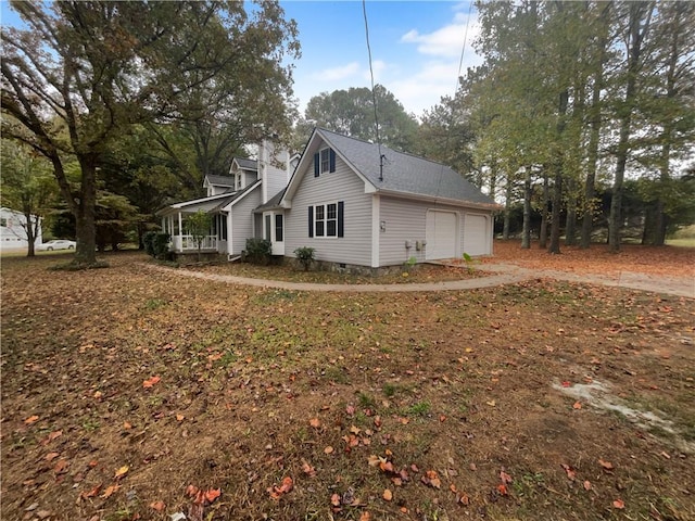 view of side of home with a porch and a garage