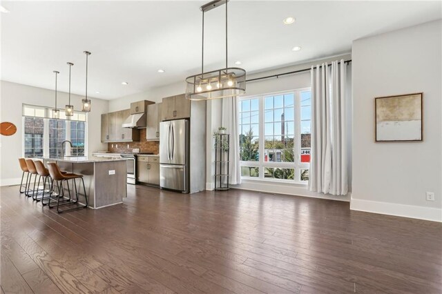 264 Castleberry Station Dr SW, Atlanta, GA 30313 - kitchen with stainless steel appliances, light countertops, dark wood-type flooring, and under cabinet range hood