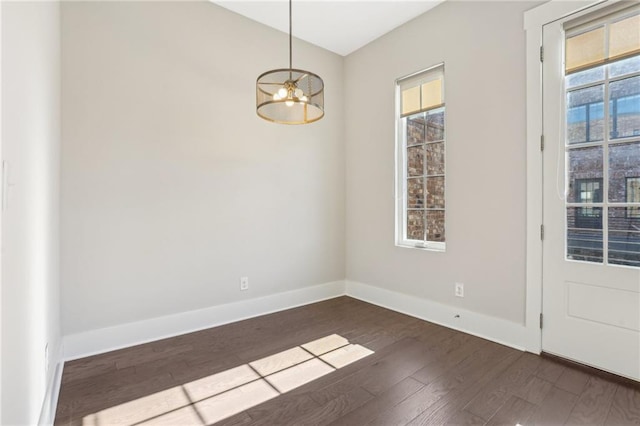 264 Castleberry Station Dr SW, Atlanta, GA 30313 - unfurnished room featuring a healthy amount of sunlight, dark wood finished floors, baseboards, and an inviting chandelier