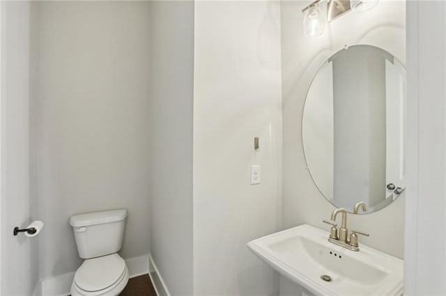 264 Castleberry Station Dr SW, Atlanta, GA 30313 - half bathroom with a sink, toilet, and baseboards