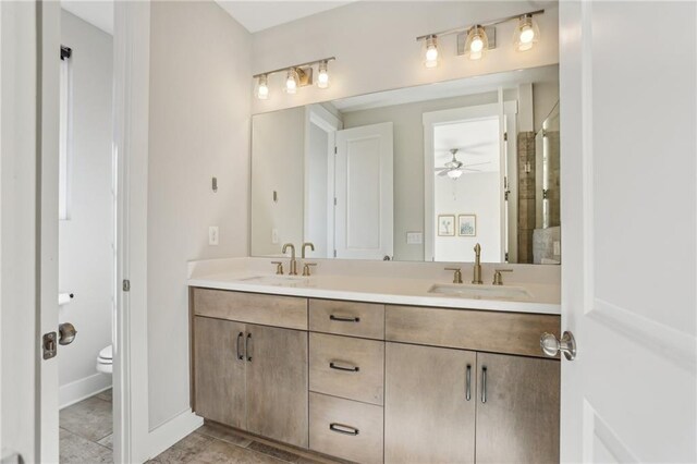 264 Castleberry Station Dr SW, Atlanta, GA 30313 - full bathroom featuring double vanity, baseboards, toilet, and a sink