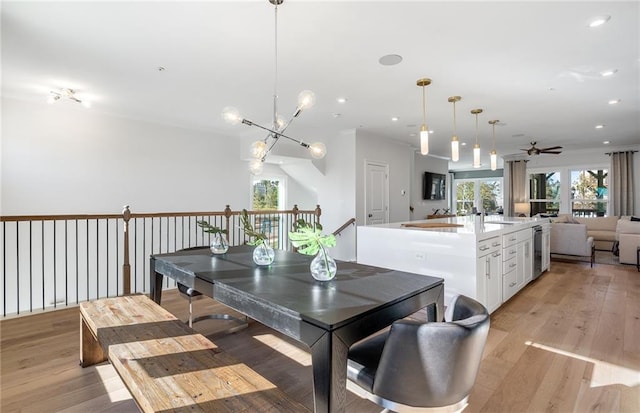 dining space featuring ceiling fan and light wood-type flooring