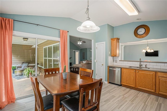 dining area with light wood-style flooring, ceiling fan with notable chandelier, and lofted ceiling