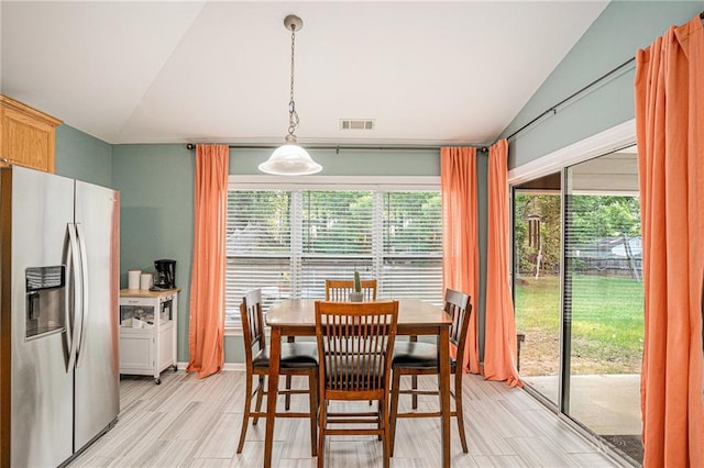 dining area with visible vents and lofted ceiling
