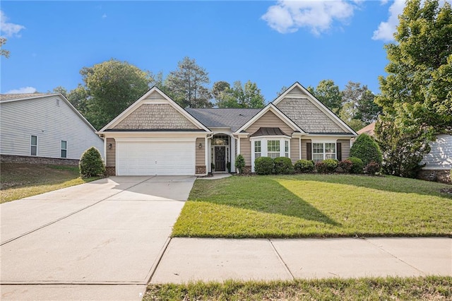 craftsman house with an attached garage, driveway, and a front yard