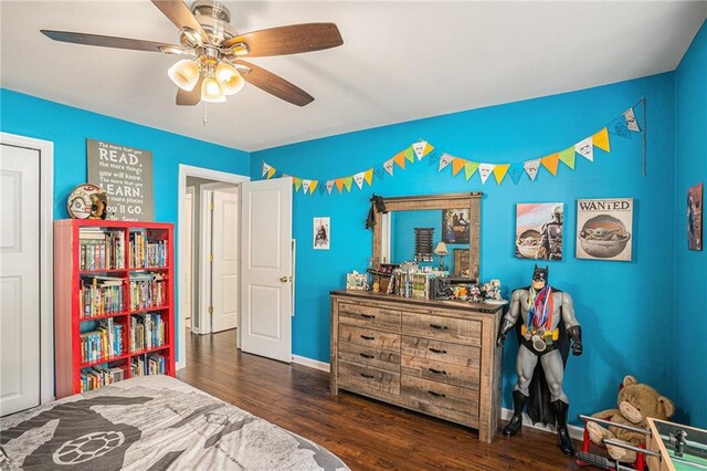 bedroom featuring baseboards, ceiling fan, and wood finished floors