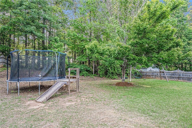 view of yard featuring a fenced backyard and a trampoline