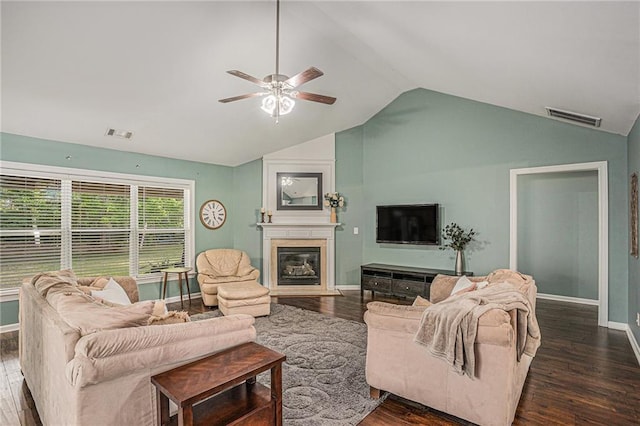 living room with baseboards, ceiling fan, lofted ceiling, and dark wood-style floors