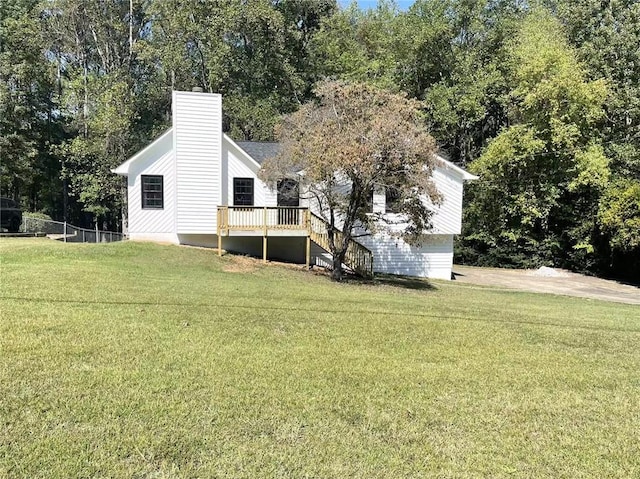 exterior space with a wooden deck and a yard