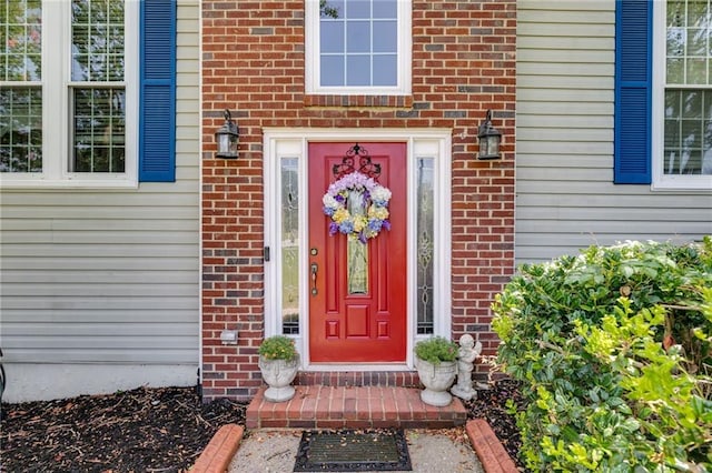 property entrance featuring brick siding