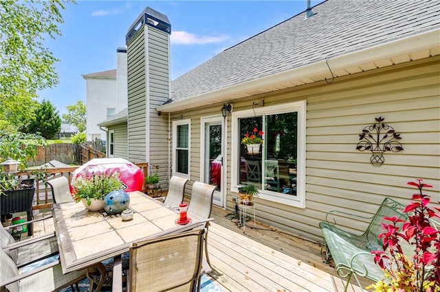 wooden terrace with fence and outdoor dining space