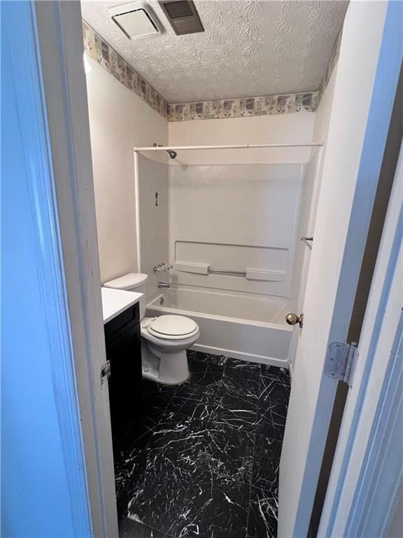 bathroom with toilet, marble finish floor, tub / shower combination, a textured ceiling, and vanity