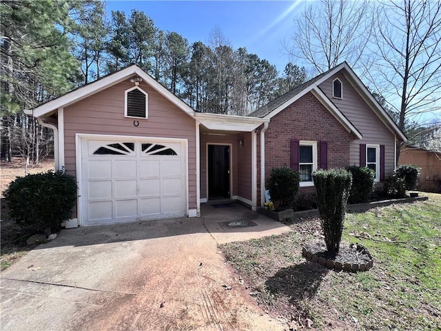 ranch-style house featuring a garage, concrete driveway, and brick siding