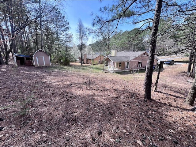 view of yard featuring an outbuilding and a storage shed