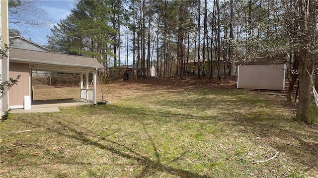 view of yard with an outbuilding and a shed