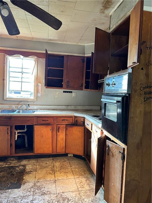405 Magnolia St, La Fayette, GA 30728 - kitchen with black oven, open shelves, a sink, and light countertops