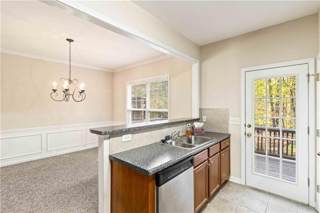 kitchen featuring sink, tasteful backsplash, dishwasher, kitchen peninsula, and pendant lighting