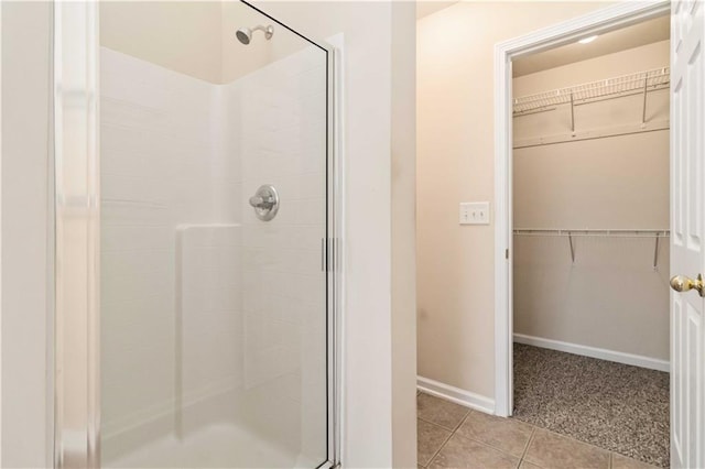 bathroom with tile patterned floors and walk in shower