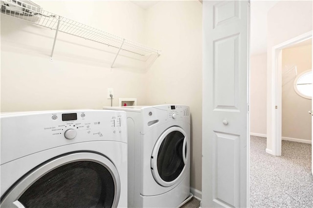 clothes washing area featuring washer and dryer and carpet