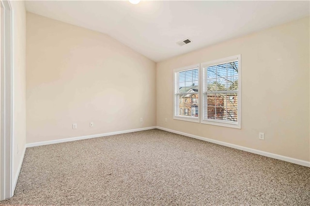 empty room with lofted ceiling and carpet floors