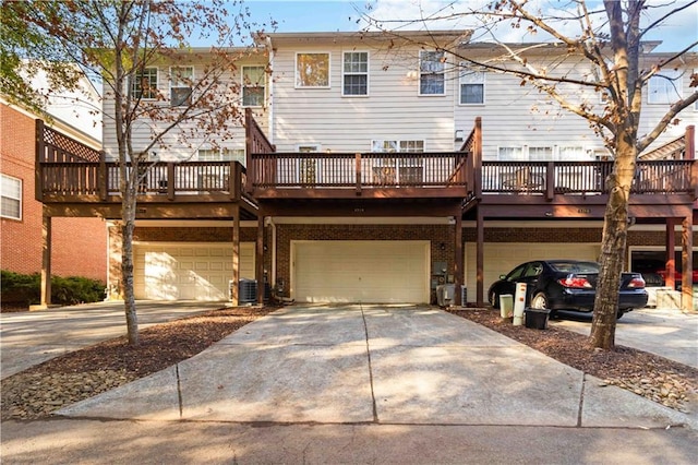 rear view of property featuring central AC, a garage, and a wooden deck