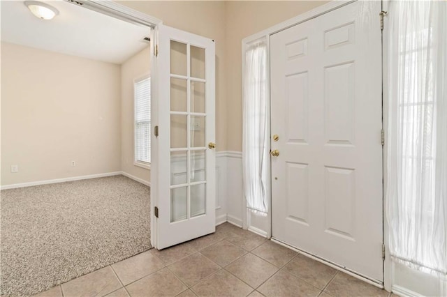 view of carpeted foyer entrance