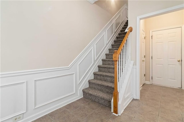 stairway with tile patterned flooring