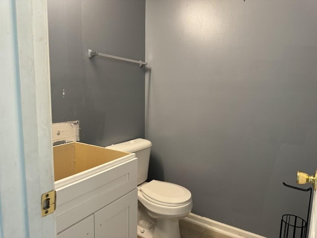 bathroom with vanity, toilet, and tile patterned floors