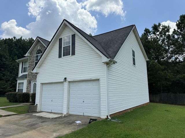 view of side of home with a garage and a lawn