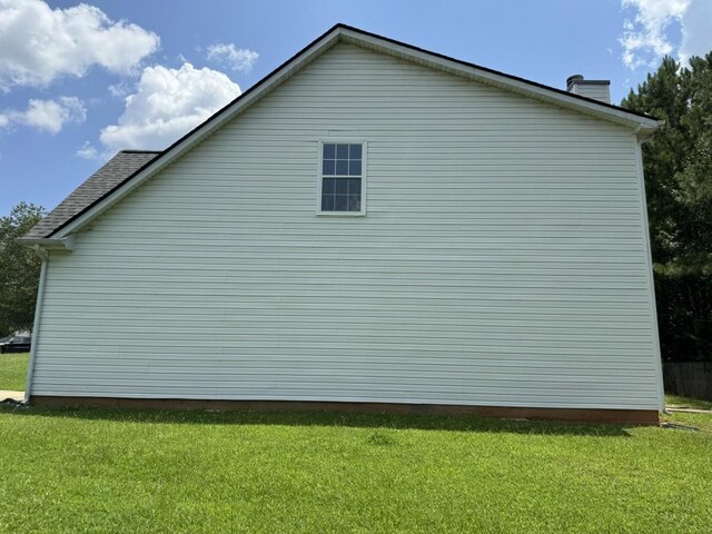 view of side of home with a lawn