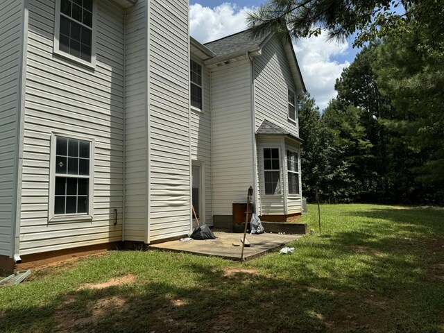 rear view of property with a patio area and a lawn