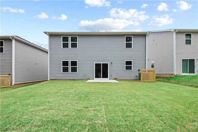 rear view of house featuring a yard