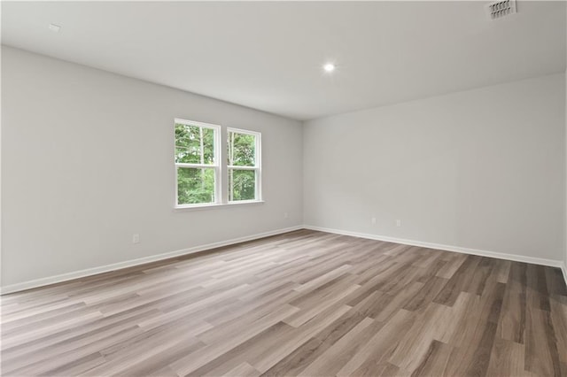 spare room with wood-type flooring