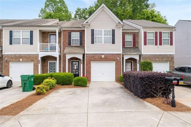 2826 Snapfinger Mnr, Decatur, GA 30035 - townhome / multi-family property featuring concrete driveway, brick siding, and a garage