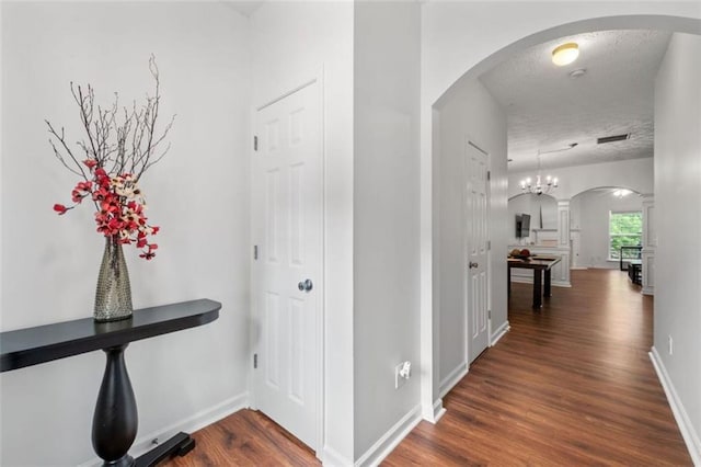 2826 Snapfinger Mnr, Decatur, GA 30035 - corridor with baseboards, arched walkways, dark wood finished floors, and visible vents