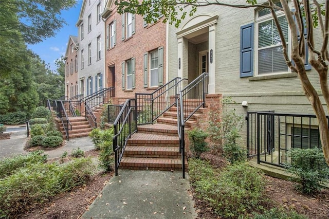 entrance to property featuring brick siding