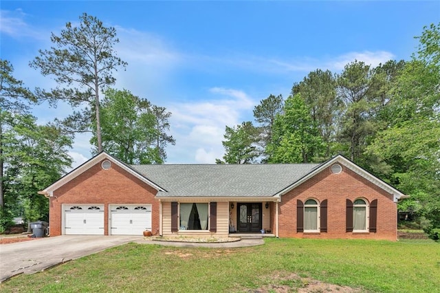 ranch-style home featuring brick siding, an attached garage, driveway, and a front yard