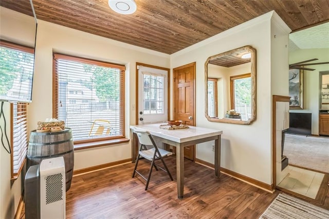 dining room with baseboards, wood ceiling, and wood finished floors