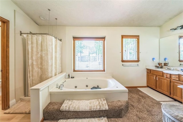 bathroom with a shower with curtain, a textured ceiling, and plenty of natural light