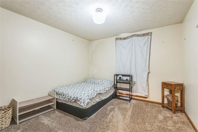 carpeted bedroom with a textured ceiling