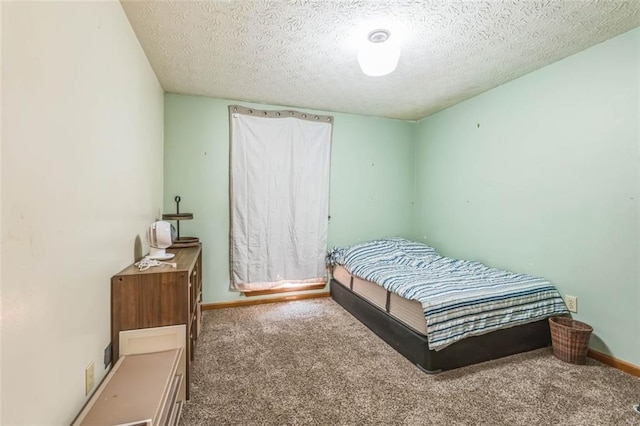 bedroom with baseboards, carpet, and a textured ceiling