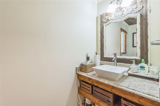 bathroom featuring ornamental molding and vanity