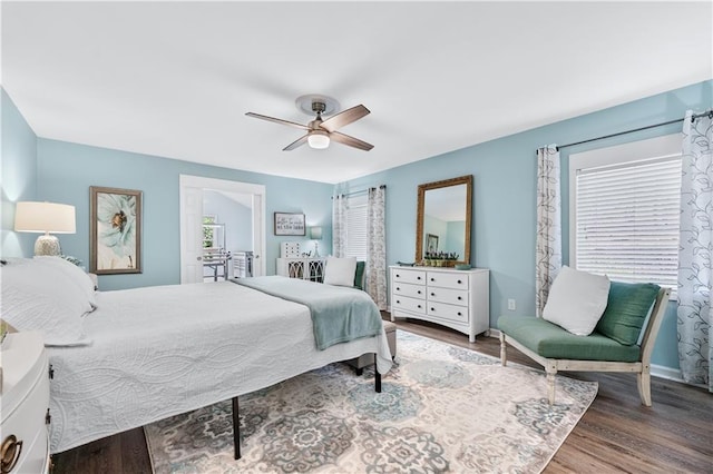 bedroom featuring a ceiling fan, baseboards, and wood finished floors