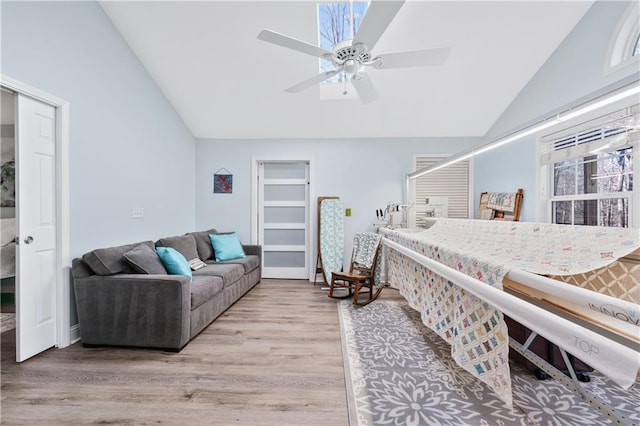 bedroom with lofted ceiling, ceiling fan, and wood finished floors