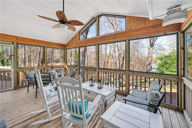 sunroom / solarium with a healthy amount of sunlight, ceiling fan, and outdoor dining space